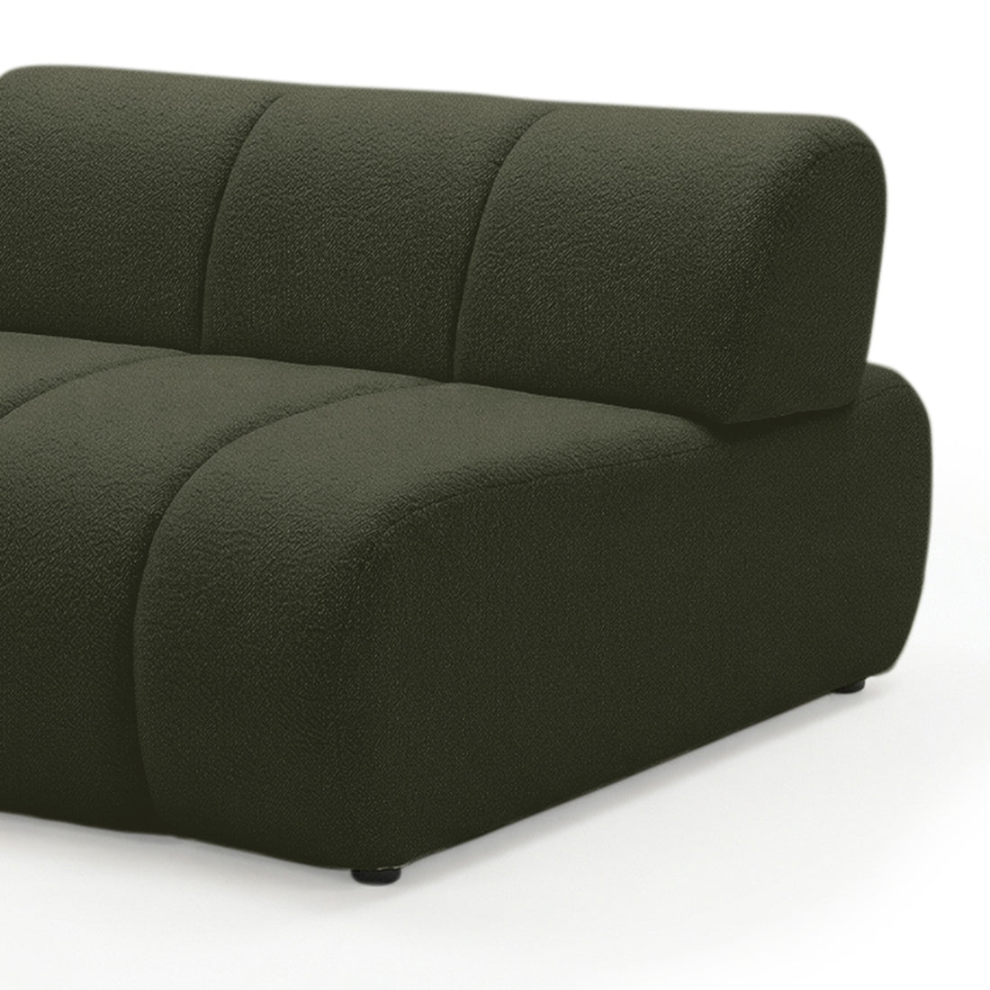 Close-up of curved modular sofa arm and backrest in dark forest green boucle fabric on white background