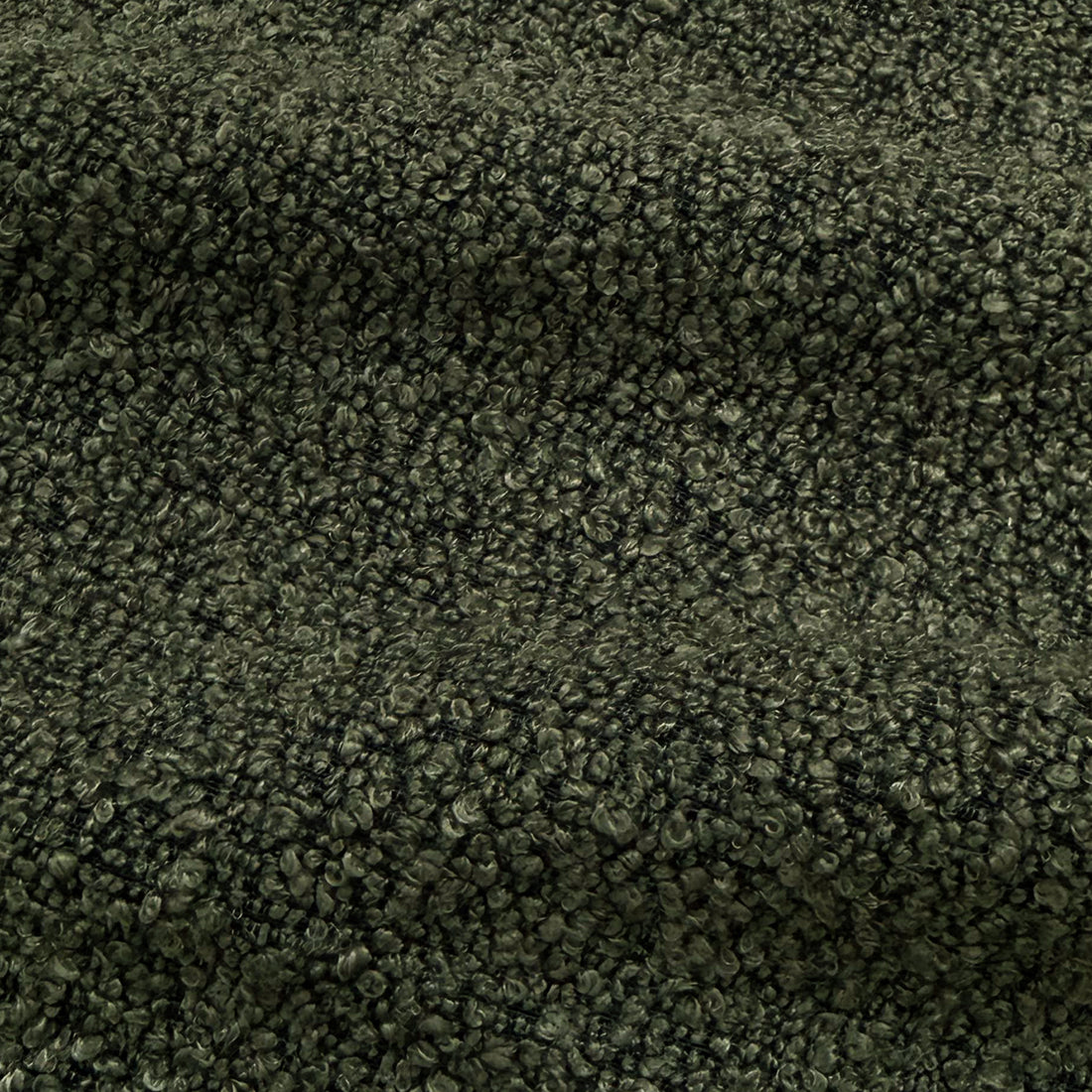 Close-up of dark forest green boucle fabric texture with woven looped fibres