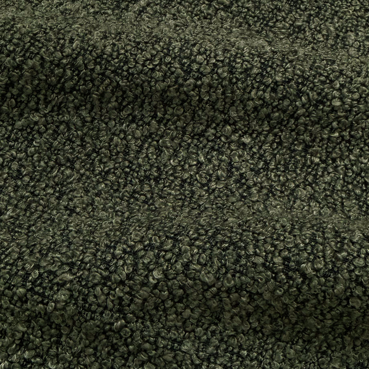 Close-up of dark forest green boucle fabric texture with woven looped fibres