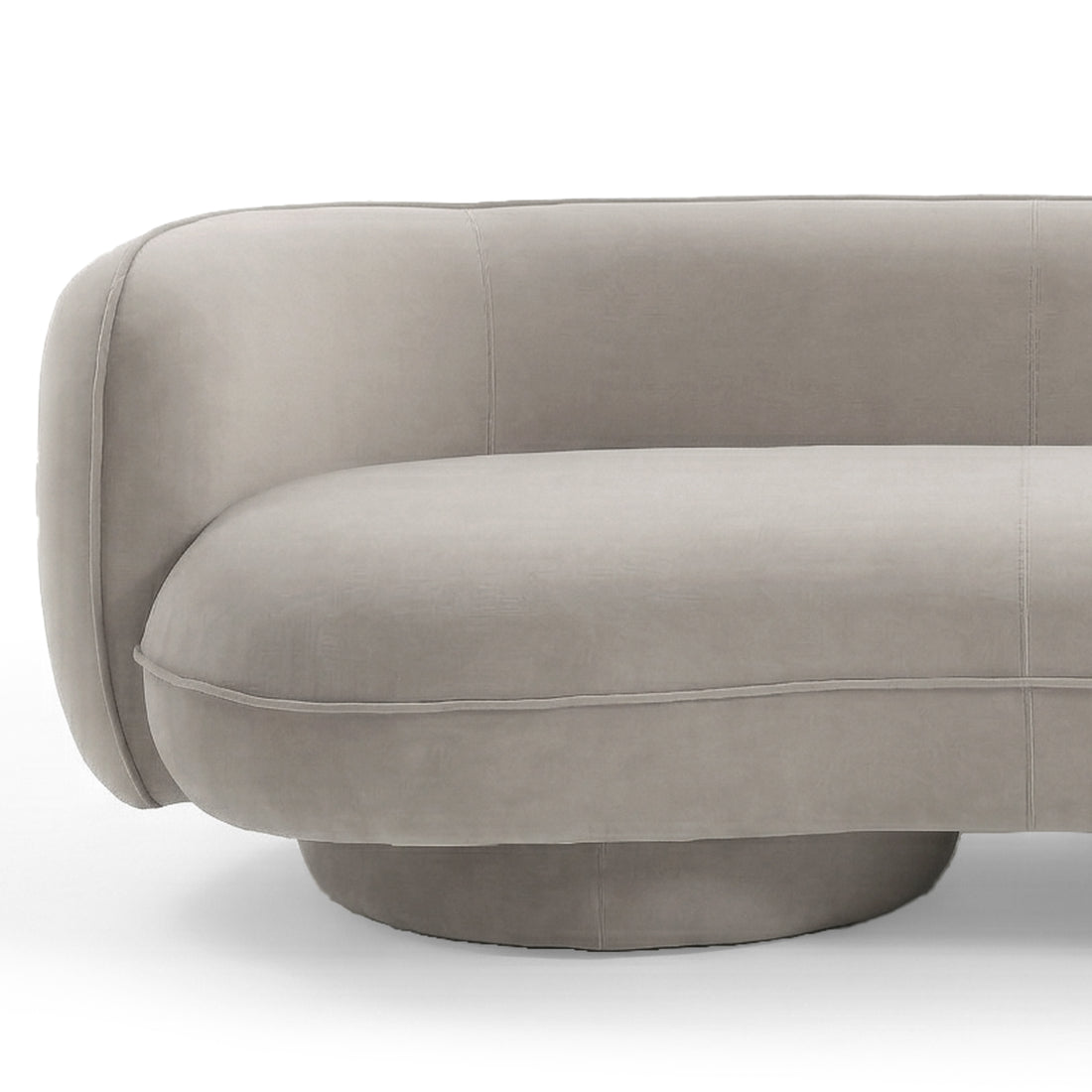 Curved warm beige velvet sofa with rounded armrest, plush seat cushion and circular base on white background