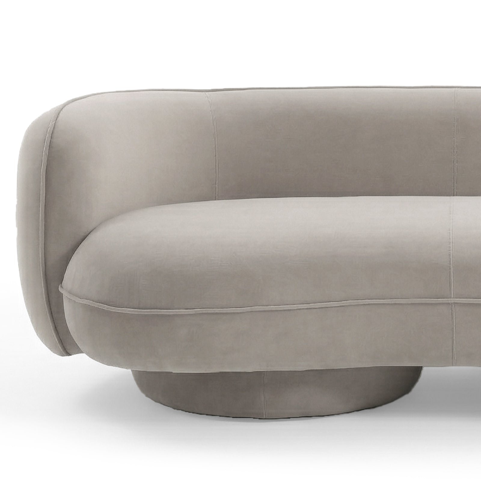 Curved warm beige velvet sofa with rounded armrest, plush seat cushion and circular base on white background
