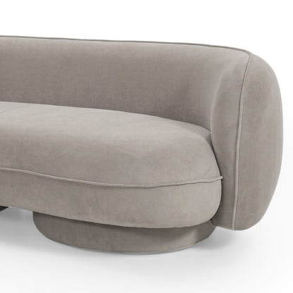 Close-up of curved armrest and cushioned seat of Torven 3 seater performance velvet sofa in warm beige with rounded base