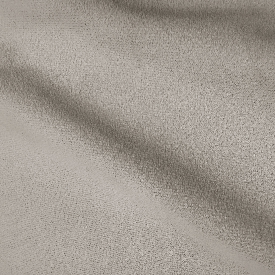 Close-up of warm beige performance velvet upholstery showing soft texture and subtle shading