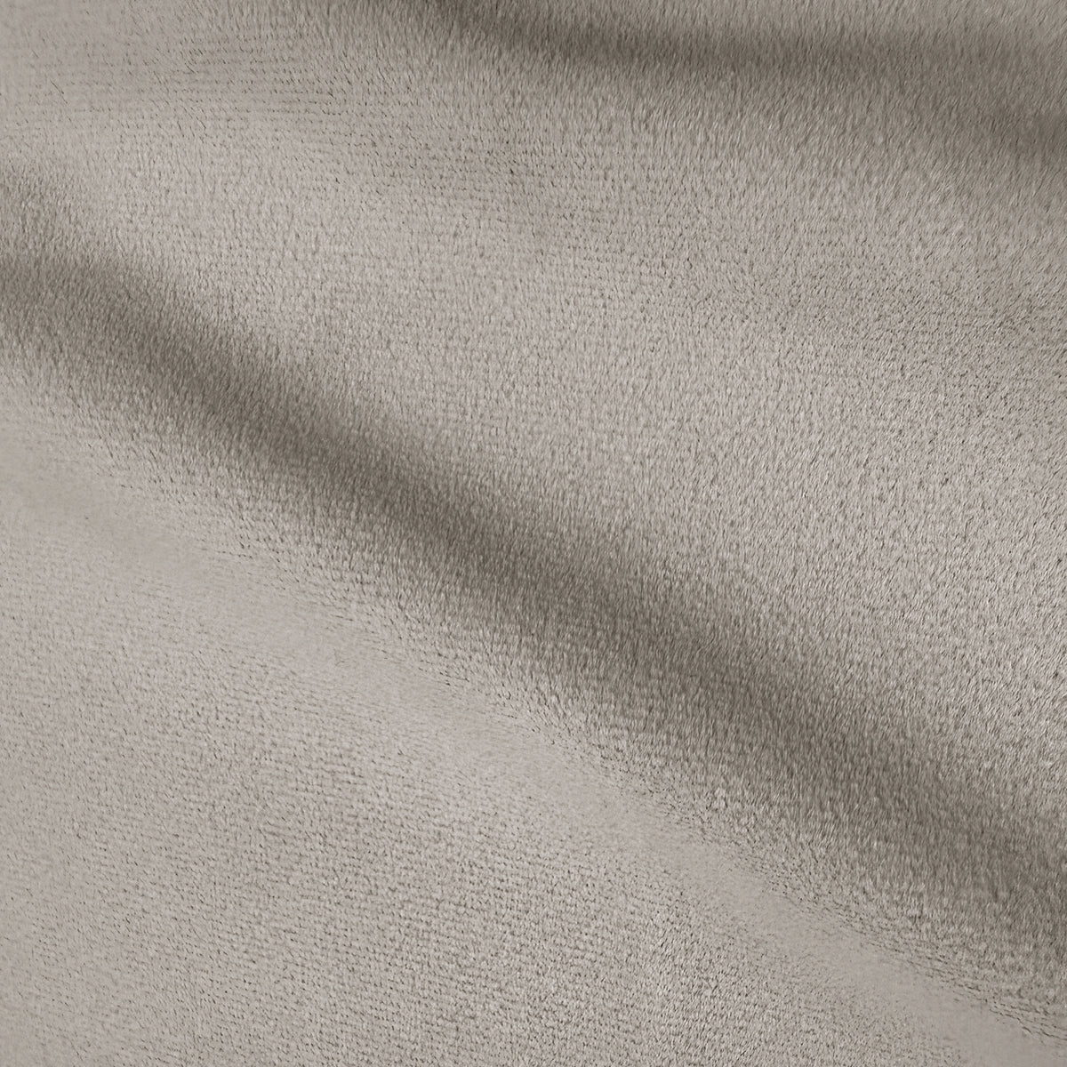 Close-up of warm beige performance velvet upholstery showing soft texture and subtle shading