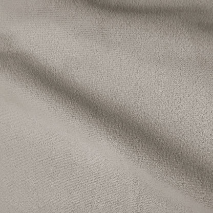 Close-up of warm beige performance velvet upholstery showing soft texture and subtle shading