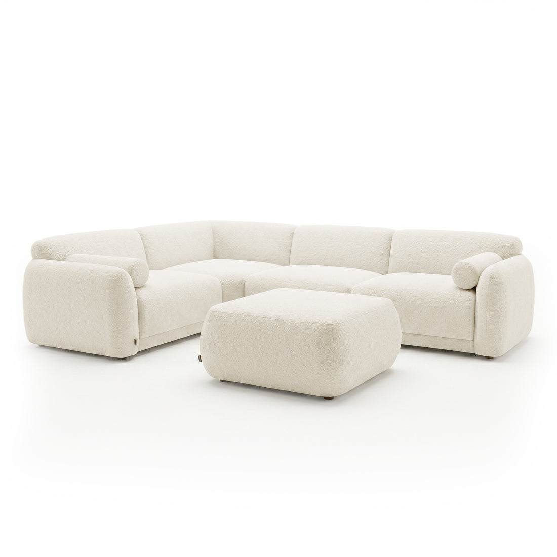 Cream sectional sofa with matching ottoman on a white background