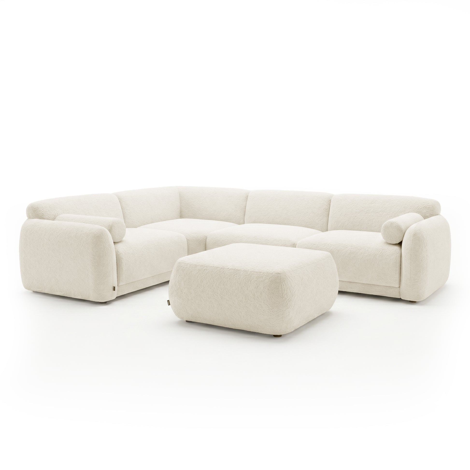 Cream sectional sofa with matching ottoman on a white background