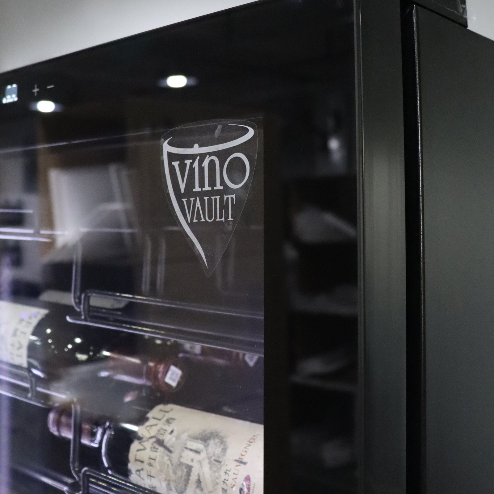 VinoVault 155 Bottle Built-In Single Zone Wine Fridge – Black, featuring a sleek, black tempered glass door with chrome accents, visible touchscreen control, and telescopic shelves, designed for seamless integration into kitchens or cellars.
