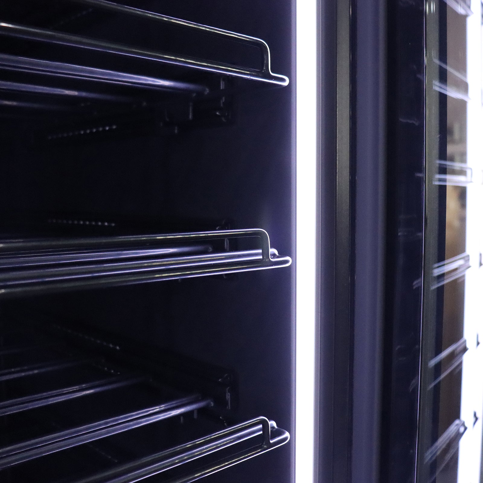 VinoVault 155 Bottle Built-In Single Zone Wine Fridge – Black, featuring a sleek black tempered glass door with a door-mounted touchscreen, showcasing its spacious interior for 155 bottles and customizable lighting.