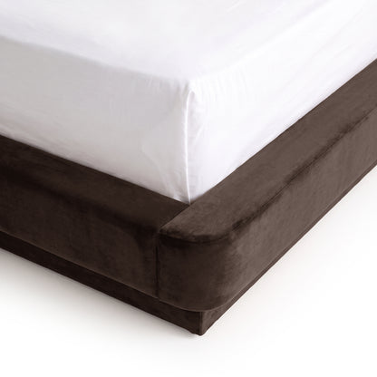 Close-up of mattress corner on a dark upholstered bed base