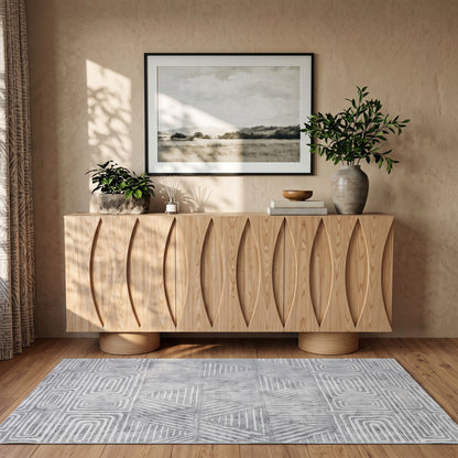 Wooden sideboard styled in a cozy room with decor and sunlight
