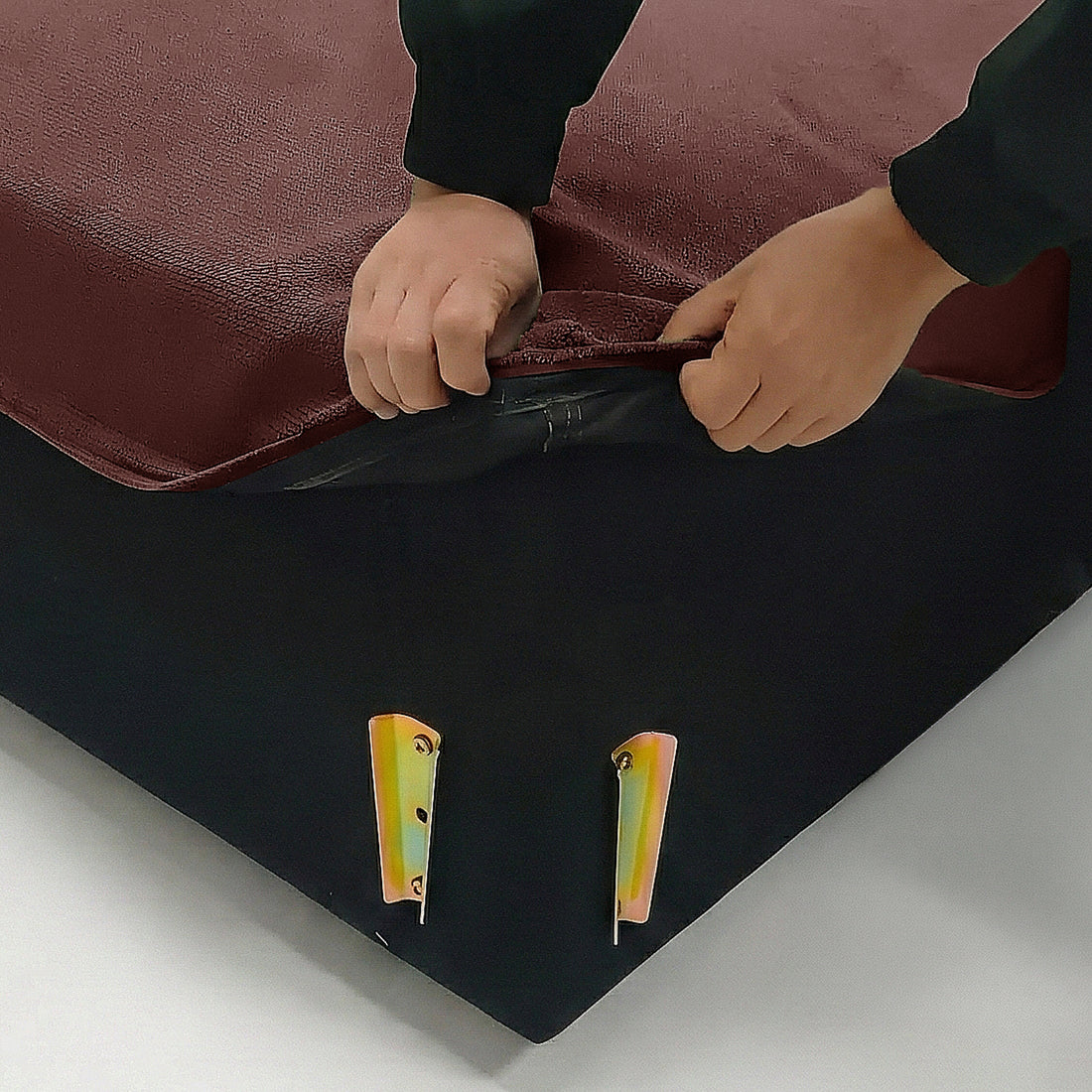 Hands lifting sofa fabric cover corner