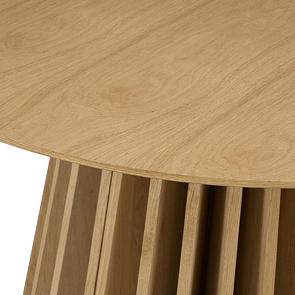 Partial view of a wooden table with slatted base on a white background