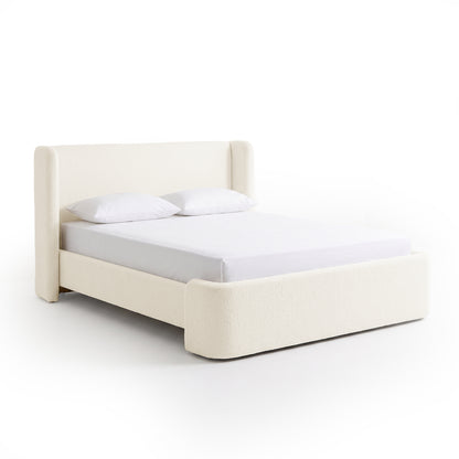 Full upholstered bed on white background, straight-on view