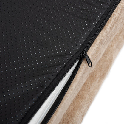 Close-up of beige and black fabric with zipper revealing inner padding
