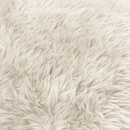 Close-up of plush cream faux fur fabric texture