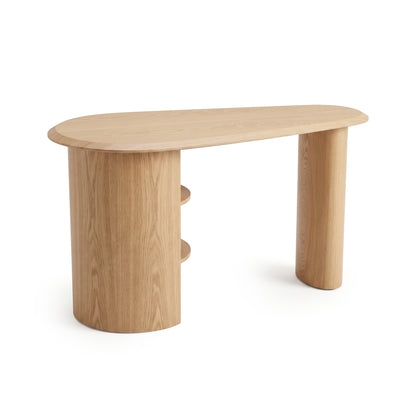 Full view of a modern wooden desk with an asymmetrical top and built-in shelf leg on a white background.