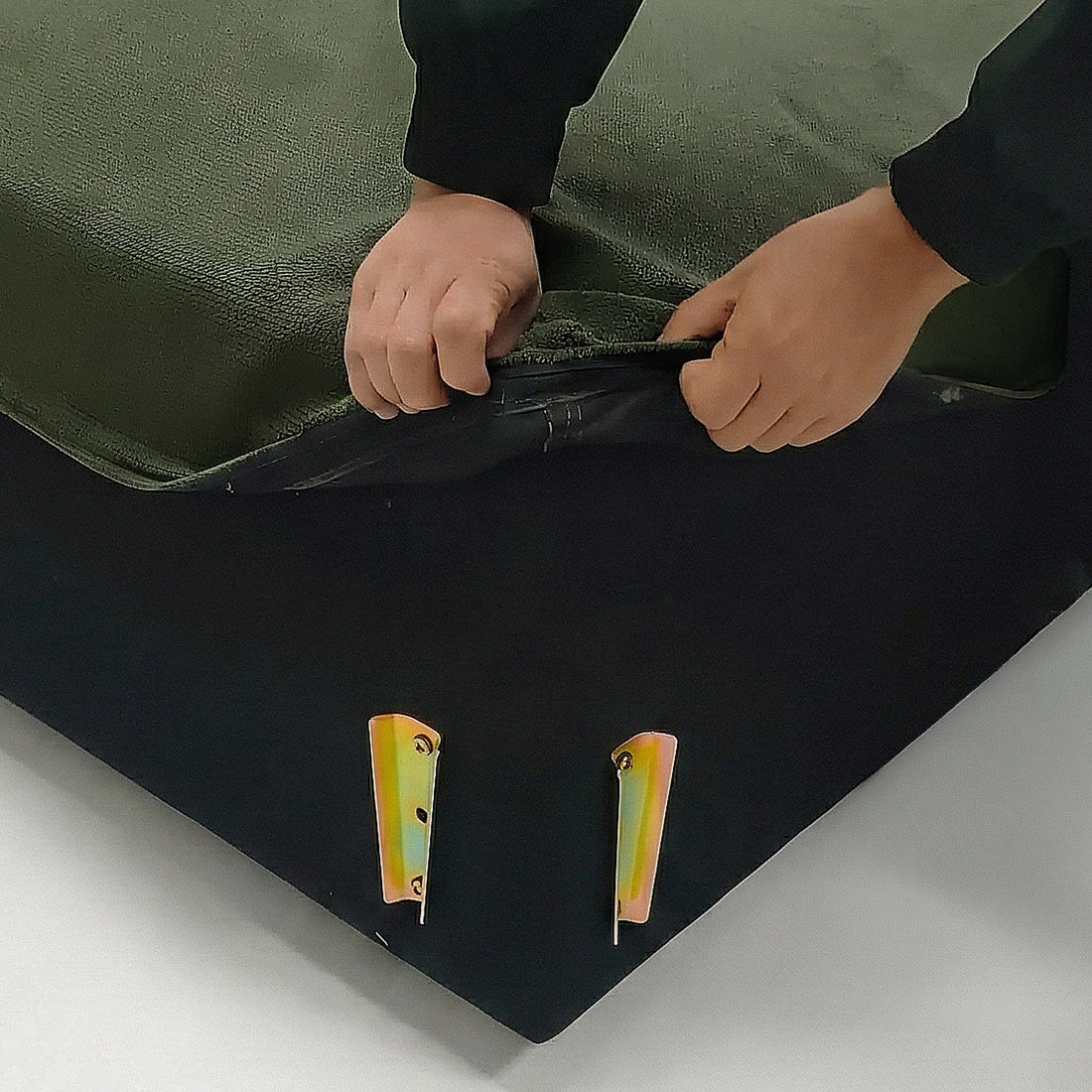 Close-up of green furniture corner with removable cover being unzipped