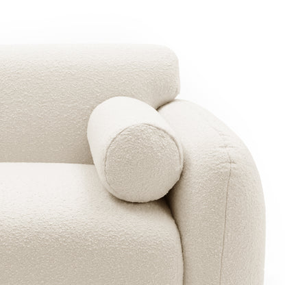 Close-up of sofa armrest and cylindrical bolster cushion on white background