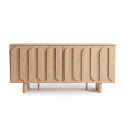 Light wood sideboard with sculptural vertically patterned front doors on a white background