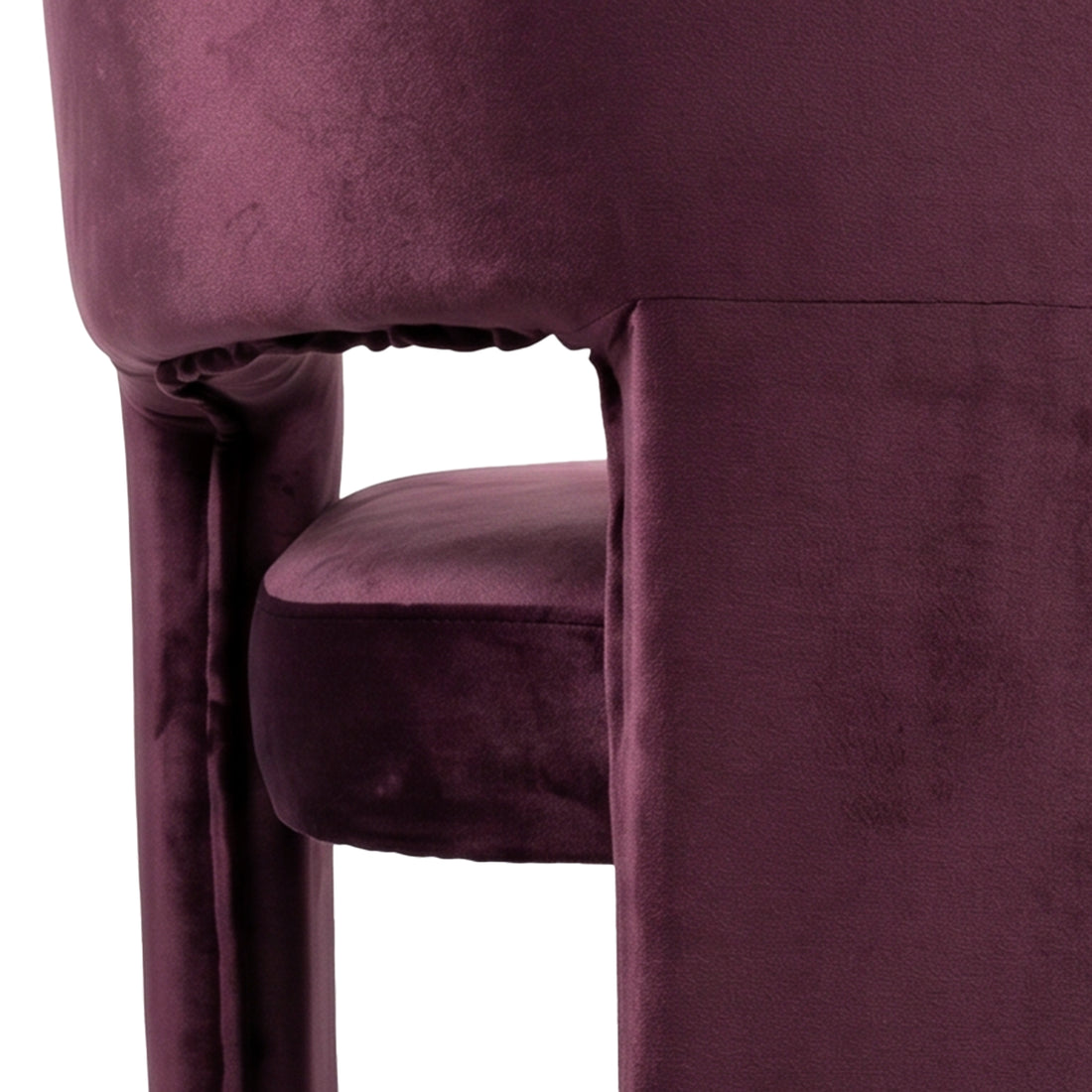 Close-up of burgundy velvet chair side and seat on white background