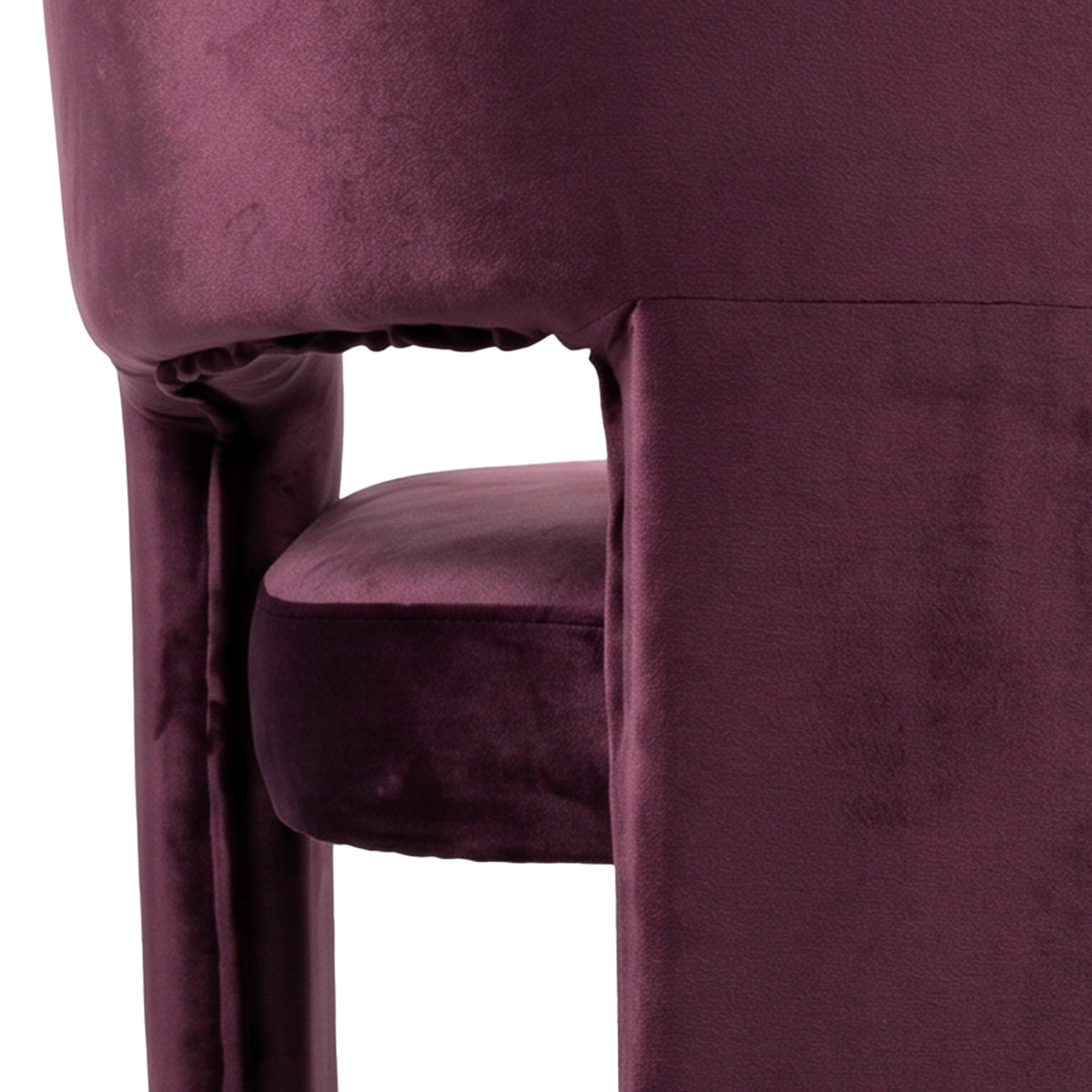 Close-up of burgundy velvet chair side and seat on white background
