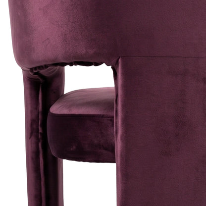 Close-up of burgundy velvet chair side and seat on white background