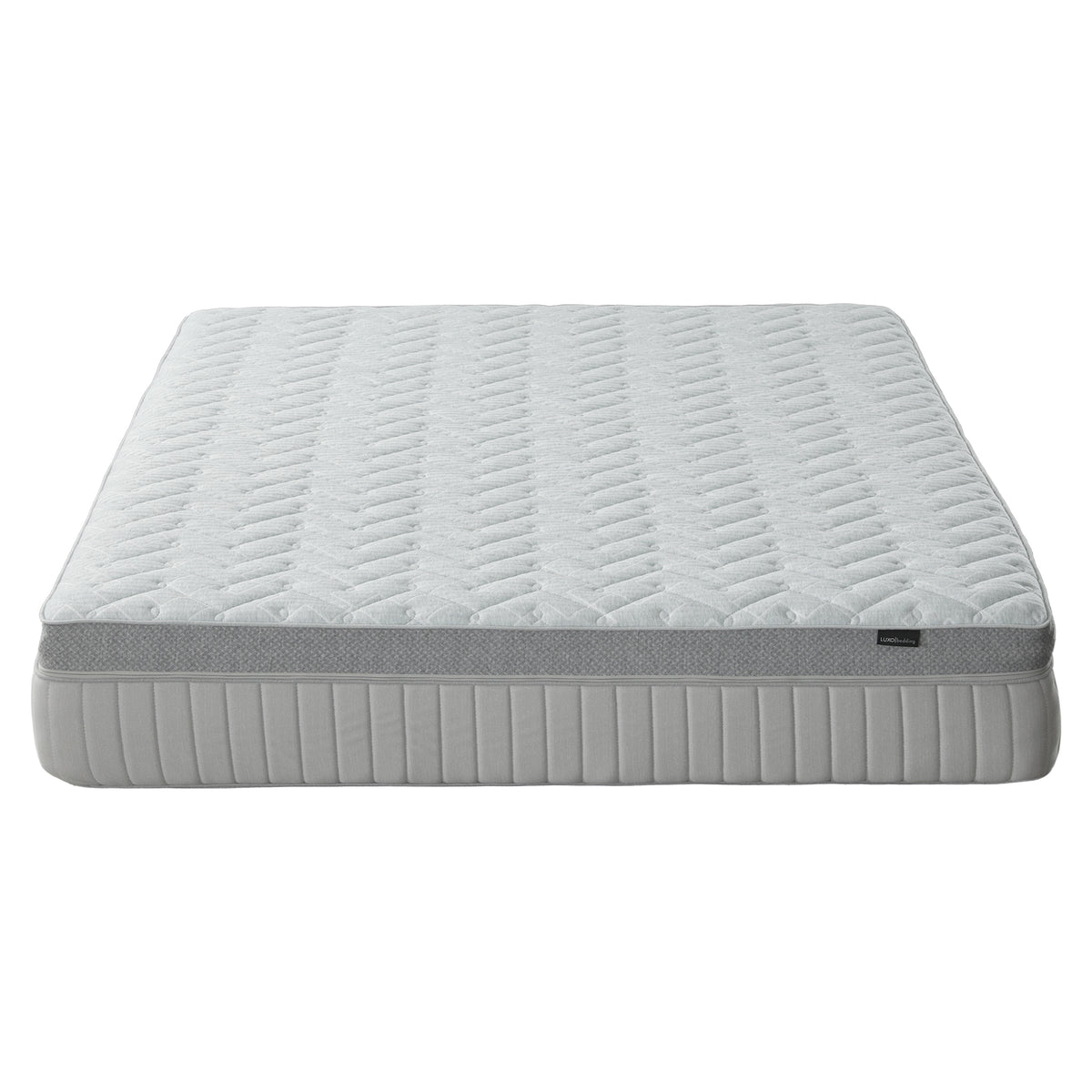 Mattress on white background shown nearly in full from a low angle