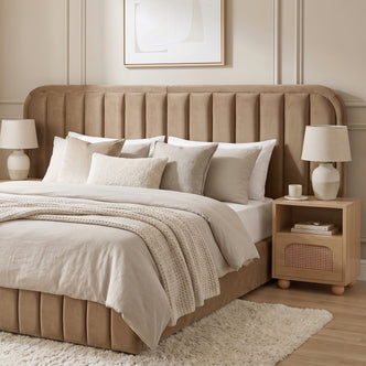 Modern upholstered bed in styled bedroom with neutral bedding