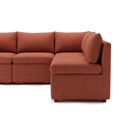 Partially cropped rust terracotta L-shaped sectional sofa on white