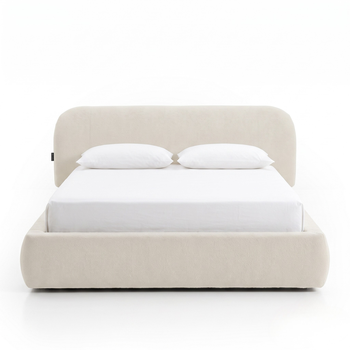 Modern upholstered bed with pillows shown fully on a white background