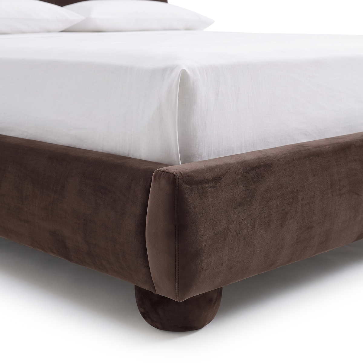 Close-up of the corner of a brown upholstered bed frame