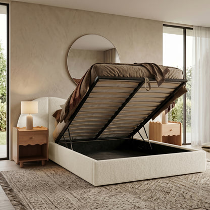 Lifestyle shot of upholstered storage bed with open under-bed compartment in bedroom
