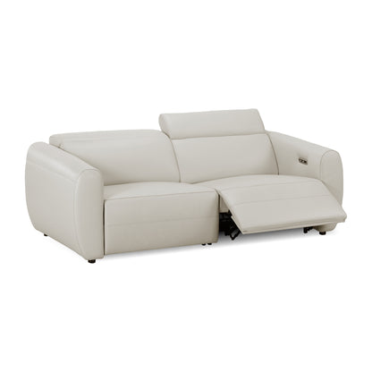 Beige reclining sofa on white background with footrest extended