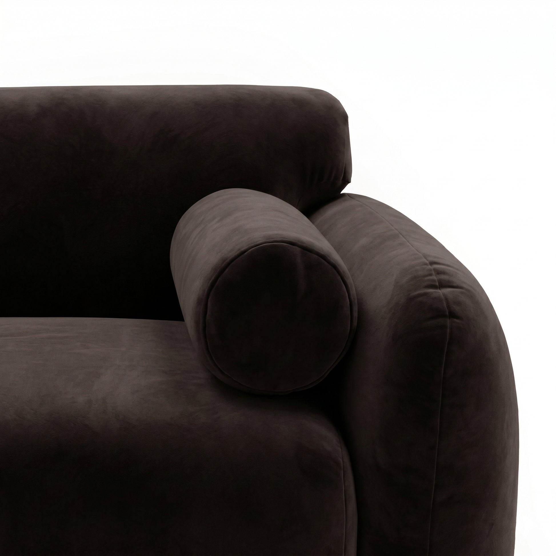 Close-up of rounded armrest and bolster pillow on sectional sofa