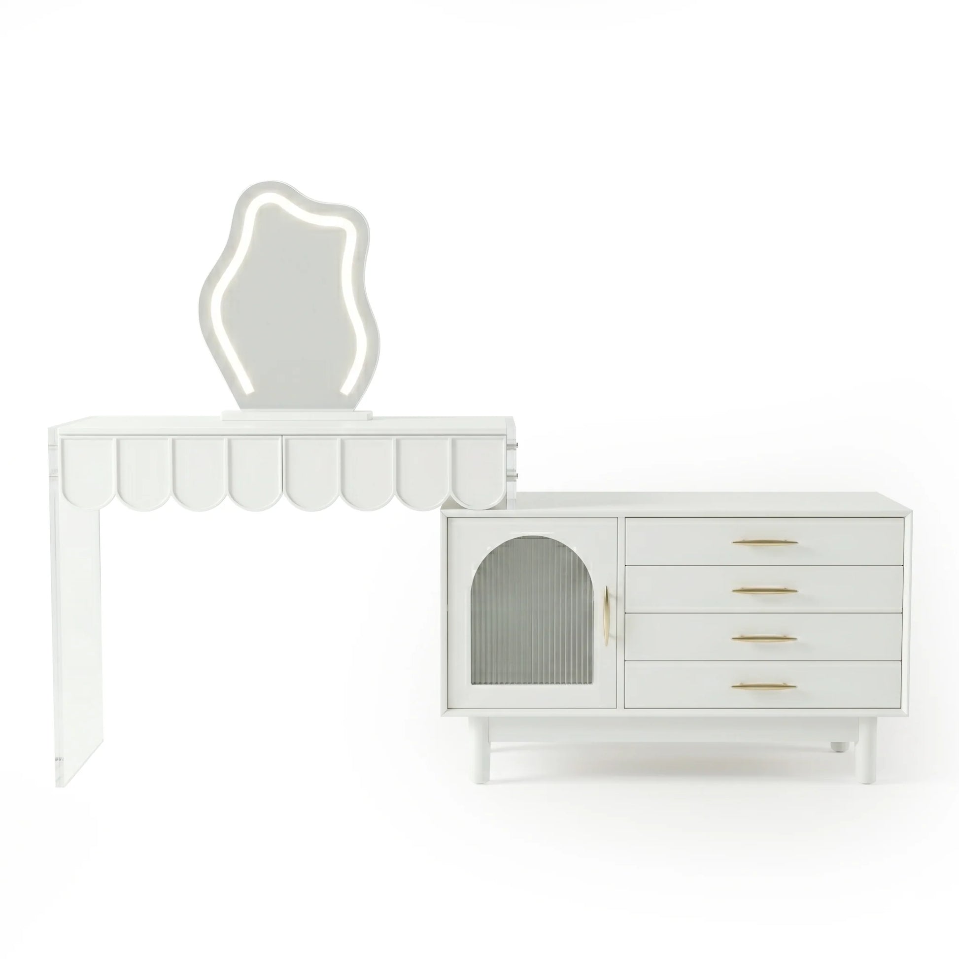 A modern white vanity set with a scalloped-edge table, a uniquely shaped illuminated mirror, and a side cabinet featuring a ribbed glass door and four drawers with gold pulls.