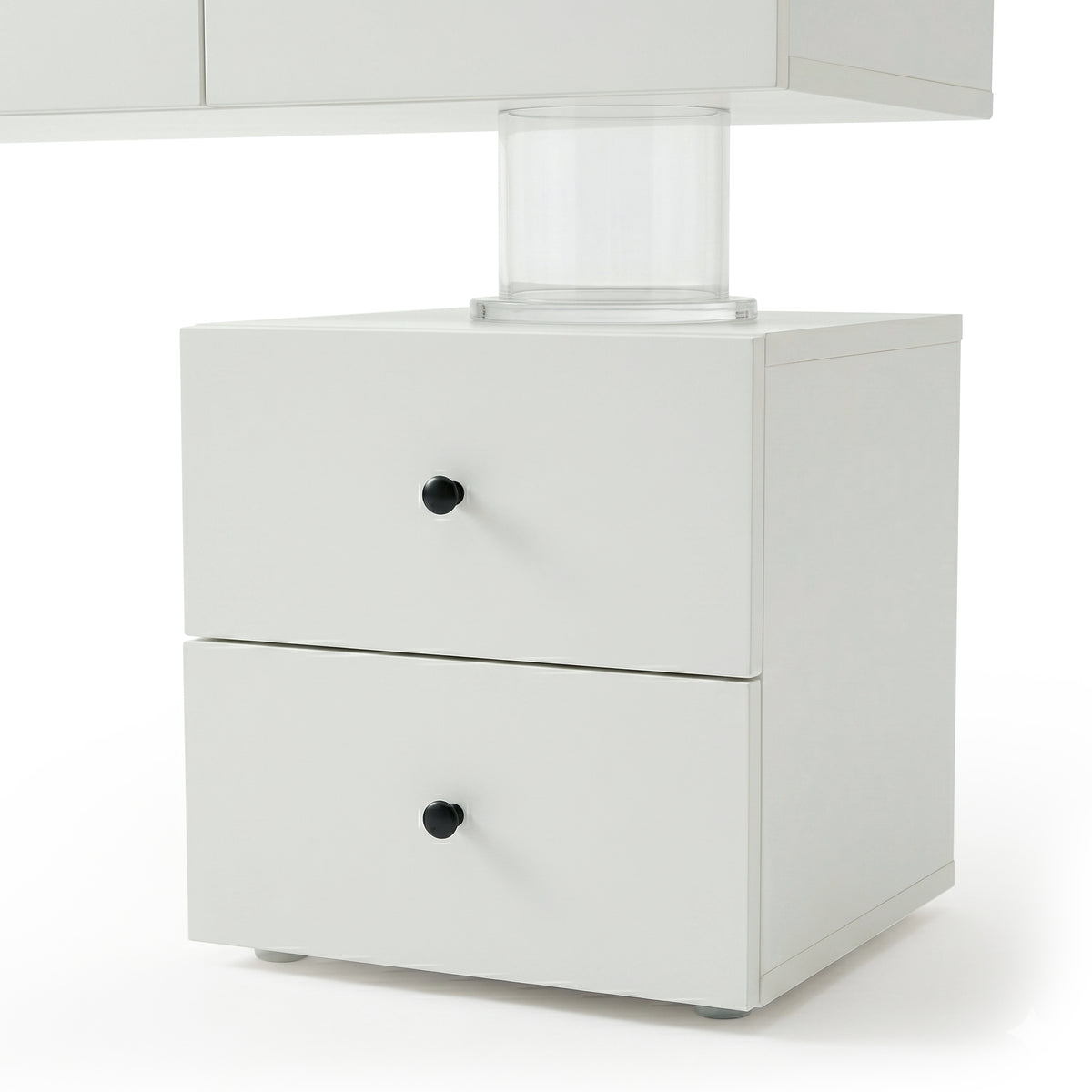 Close-up of white vanity drawer unit section on white background