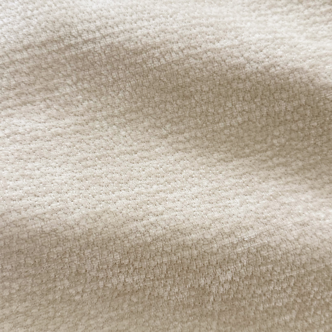 Close-up of beige upholstered fabric texture