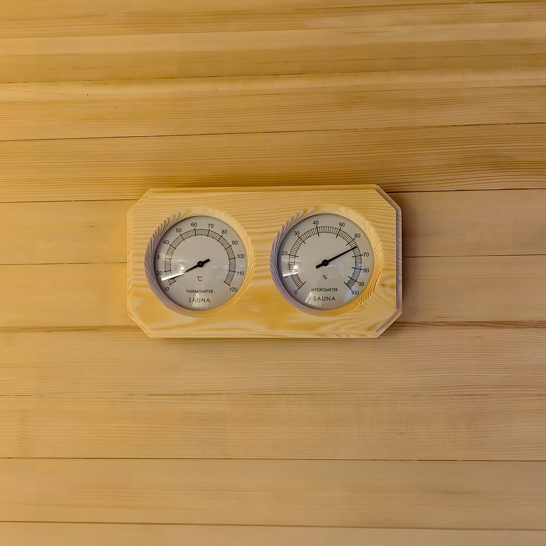 Wooden sauna thermometer and hygrometer on a wood wall