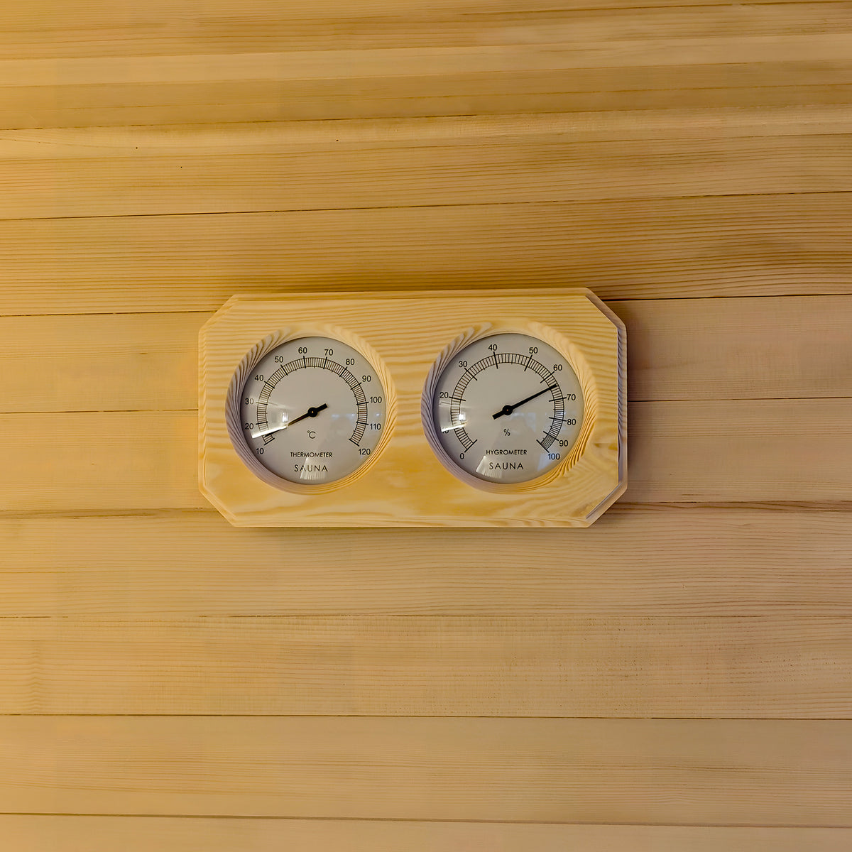 Wooden sauna thermometer and hygrometer on a wood wall