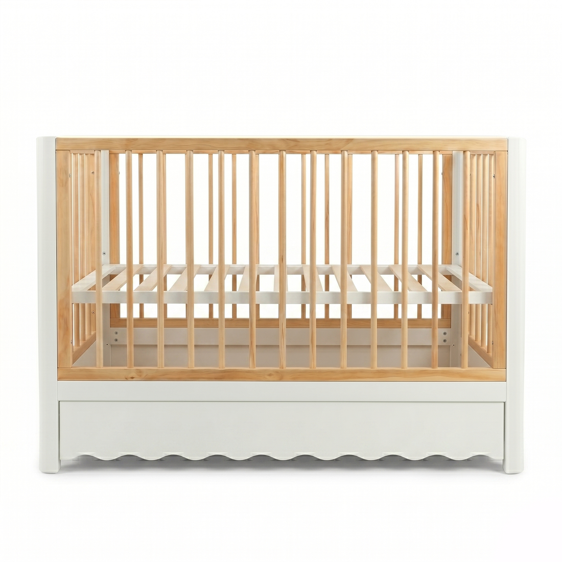 Front view wooden baby crib with scalloped white base and natural wood slats on white background