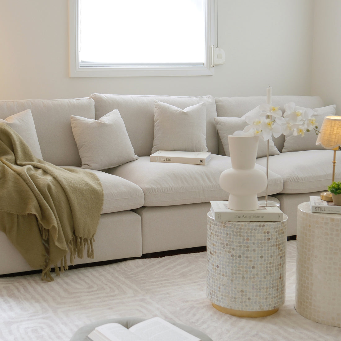 Light-colored sectional sofa in a cozy decorated living room