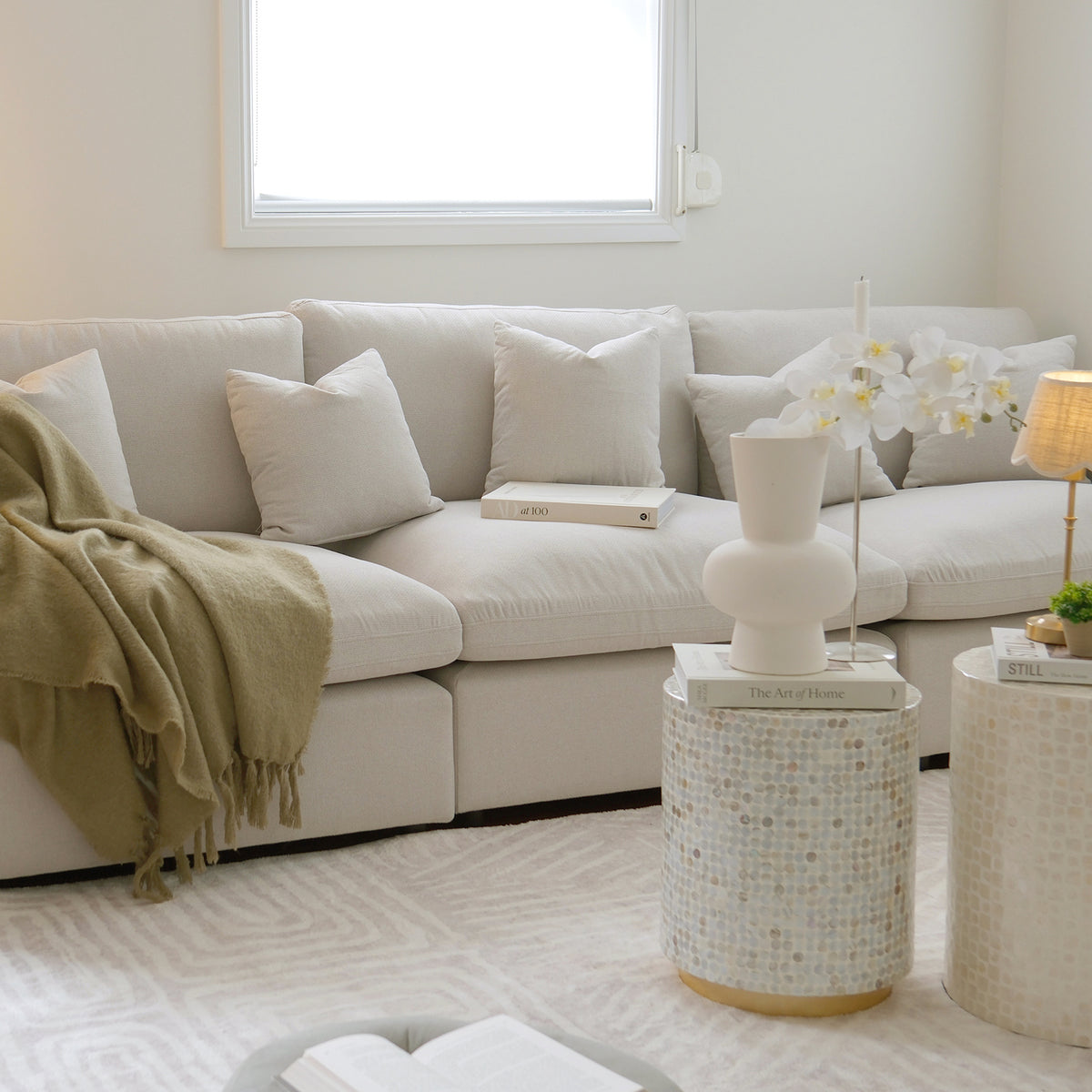 Light-colored sectional sofa in a cozy decorated living room