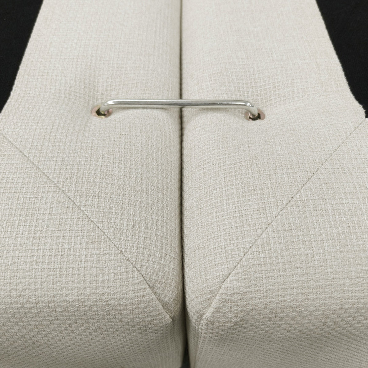 Close-up of stitched upholstered sections with a metal connector