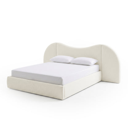 Modern upholstered bed with curved headboard and pillows on white background