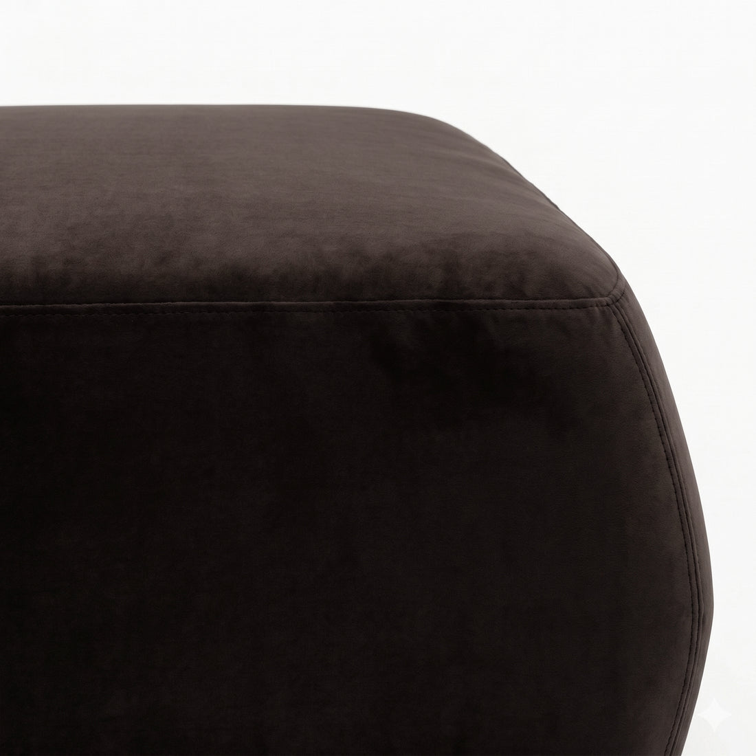 Partial top and side view of dark brown ottoman on white background