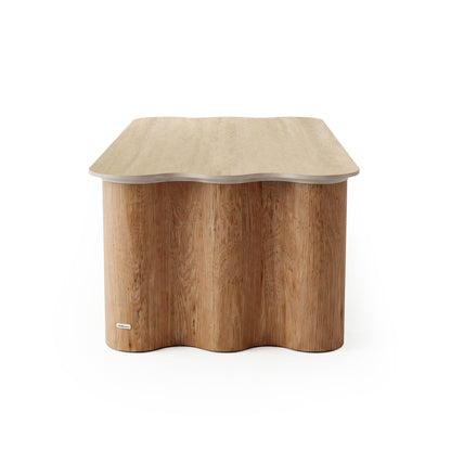 Modern wooden table with wave-edged top and cylindrical base on white background