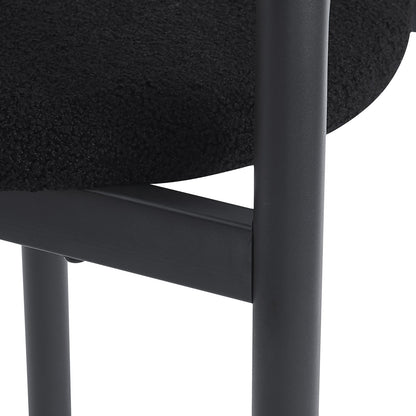 Close-up of a black chair seat and metal frame on a white background