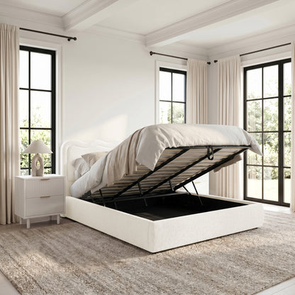 Storage bed with lift-up mattress frame in a bright, modern bedroom