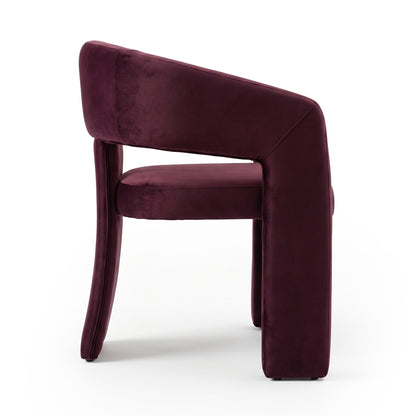 Side view of full burgundy accent chair on white background